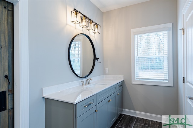 bathroom with tile patterned floors, vanity, and plenty of natural light