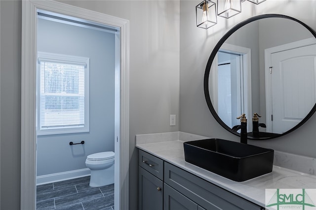 bathroom featuring tile patterned floors, vanity, and toilet