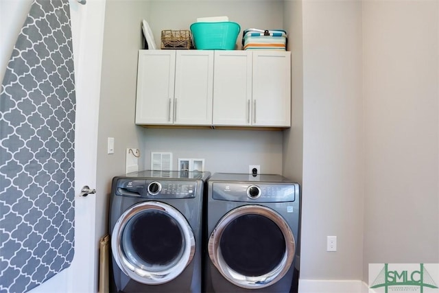 laundry room featuring cabinet space and independent washer and dryer