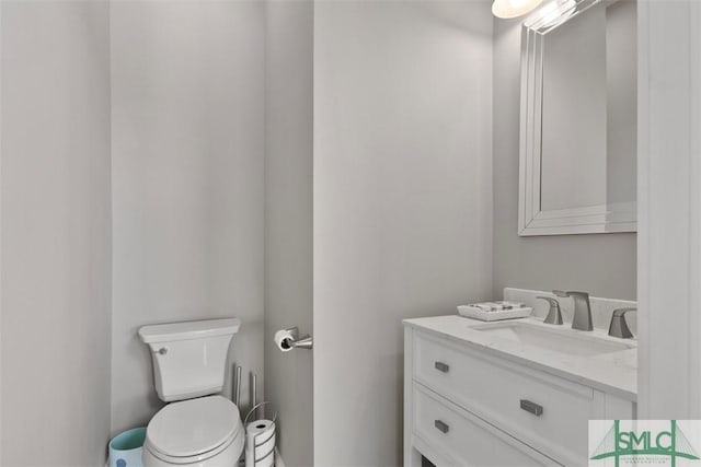 half bath featuring toilet and vanity