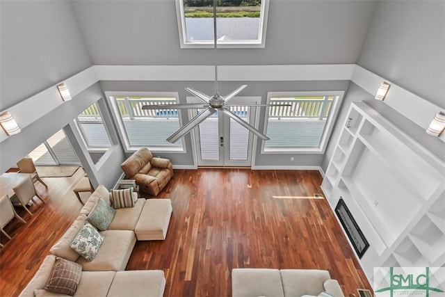 unfurnished living room featuring a wealth of natural light, a fireplace, and wood finished floors