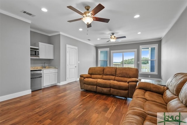 living room with dark wood-style flooring, visible vents, and baseboards