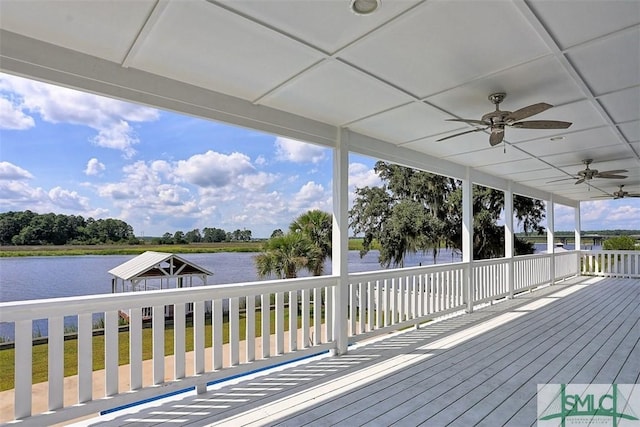 wooden terrace with ceiling fan and a water view