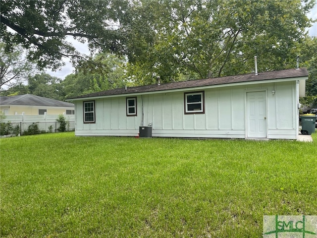 back of property featuring a lawn and central AC unit