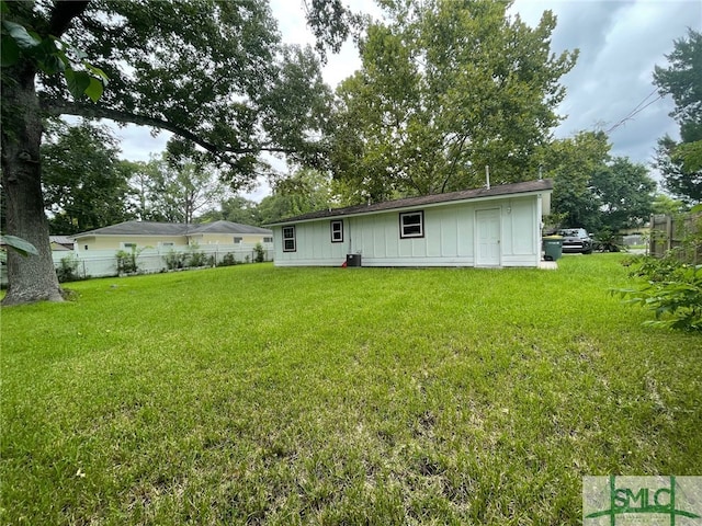 back of property featuring a lawn