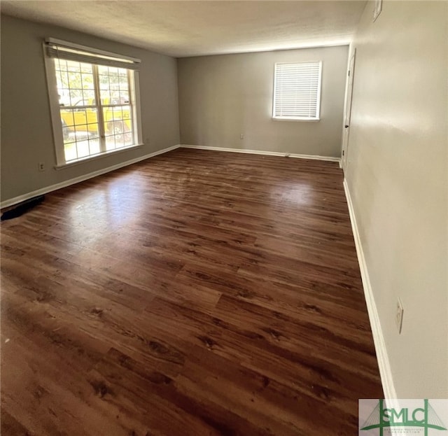 spare room featuring dark wood-type flooring