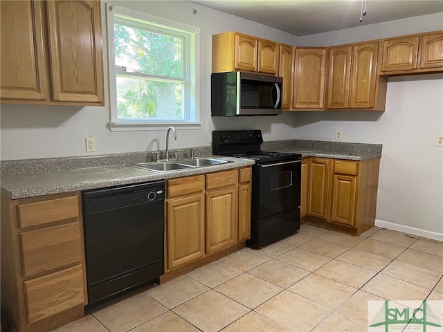 kitchen with black appliances, sink, and light tile patterned floors