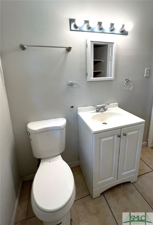 bathroom featuring vanity, toilet, and tile patterned flooring