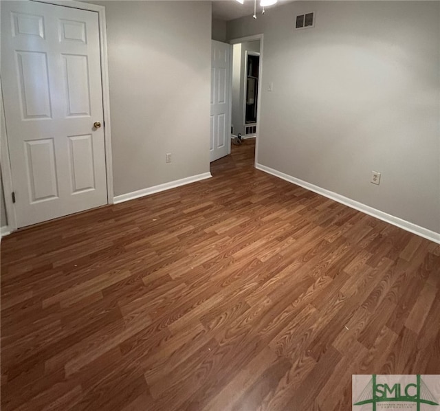 empty room with hardwood / wood-style flooring