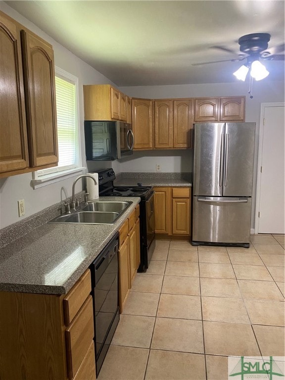 kitchen featuring appliances with stainless steel finishes, light tile patterned flooring, sink, and ceiling fan