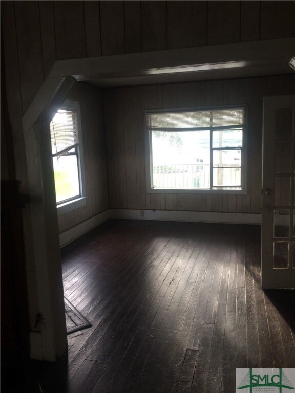 spare room with dark hardwood / wood-style floors