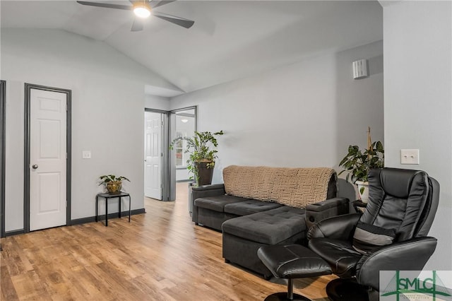 living room featuring ceiling fan, lofted ceiling, and light hardwood / wood-style floors