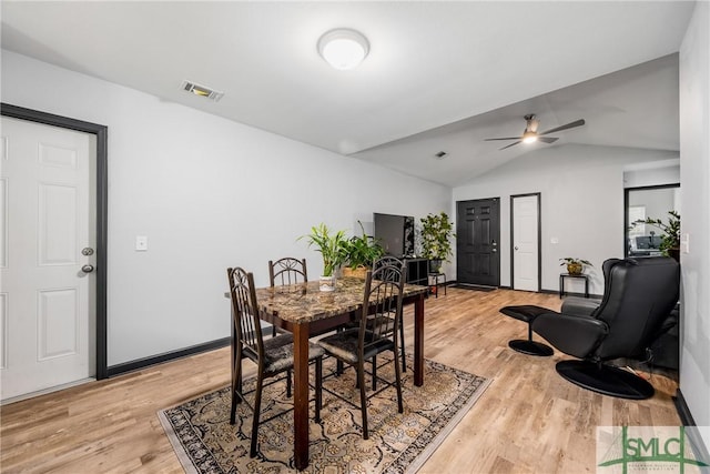 dining room featuring ceiling fan, lofted ceiling, and light hardwood / wood-style floors