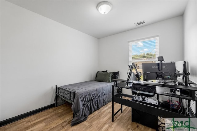 bedroom with hardwood / wood-style flooring