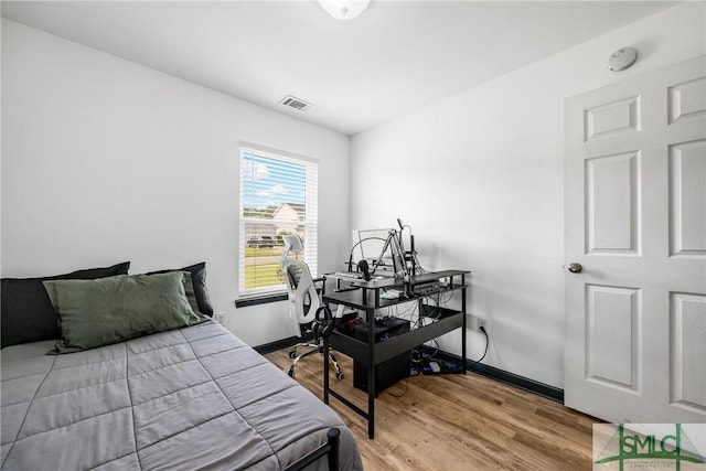 bedroom with hardwood / wood-style floors