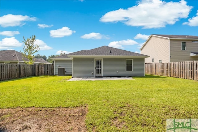 back of house featuring central AC unit, a patio area, and a lawn