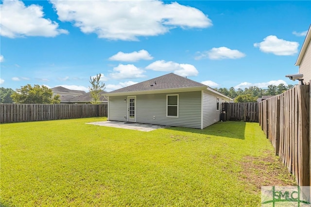 rear view of house featuring a yard and a patio area