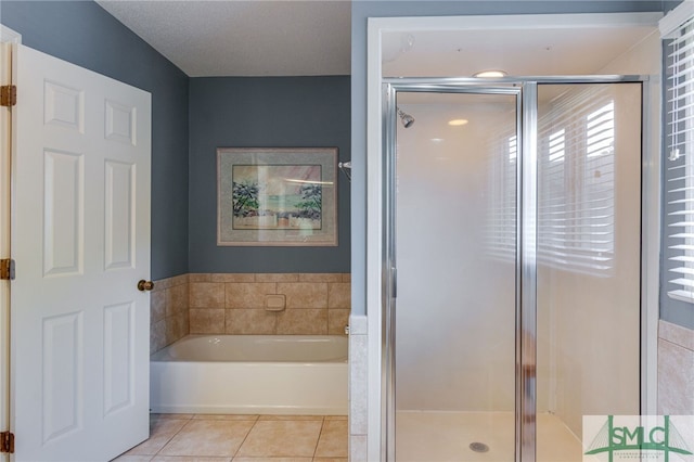 bathroom with tile patterned floors and separate shower and tub