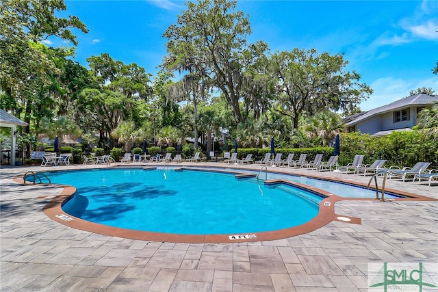 view of swimming pool with a patio area