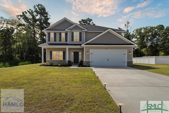 craftsman inspired home with a garage and a front yard