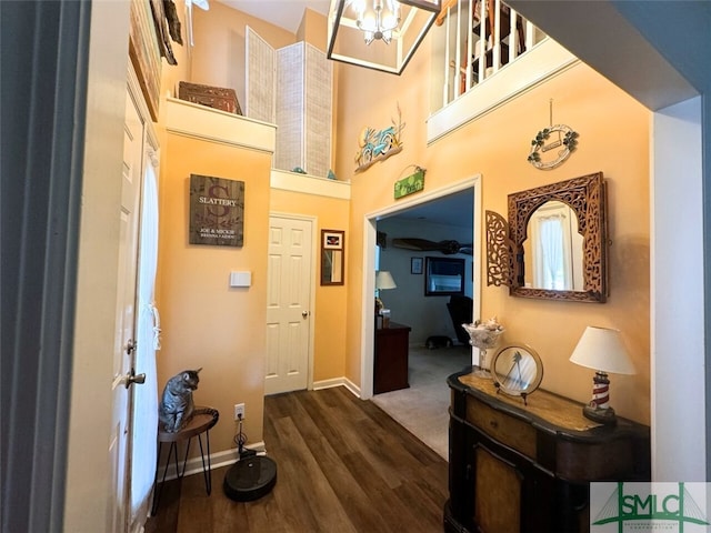 interior space with hardwood / wood-style flooring and a towering ceiling