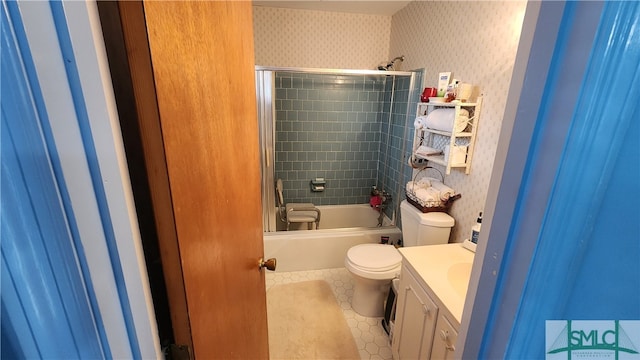 full bathroom with tiled shower / bath combo, vanity, tile patterned flooring, and toilet