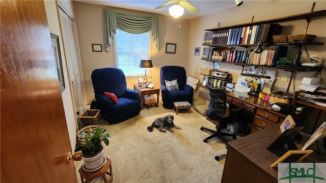 carpeted home office with ceiling fan