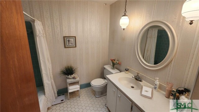 bathroom featuring vanity, toilet, and tile patterned flooring