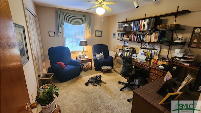 carpeted office space with ceiling fan