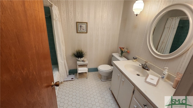 bathroom featuring toilet, vanity, and tile patterned flooring