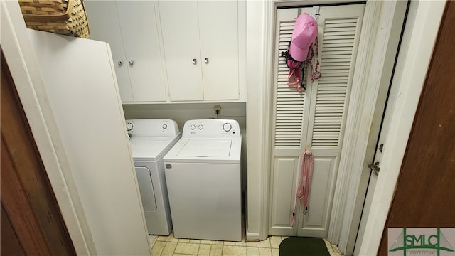 clothes washing area featuring light tile patterned floors, cabinets, and separate washer and dryer