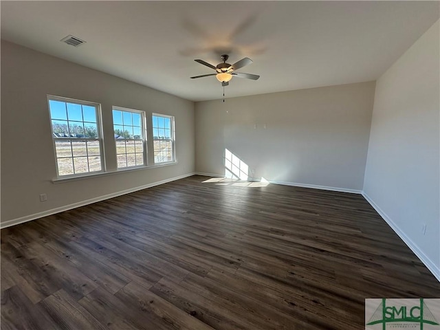 spare room with dark hardwood / wood-style floors and ceiling fan