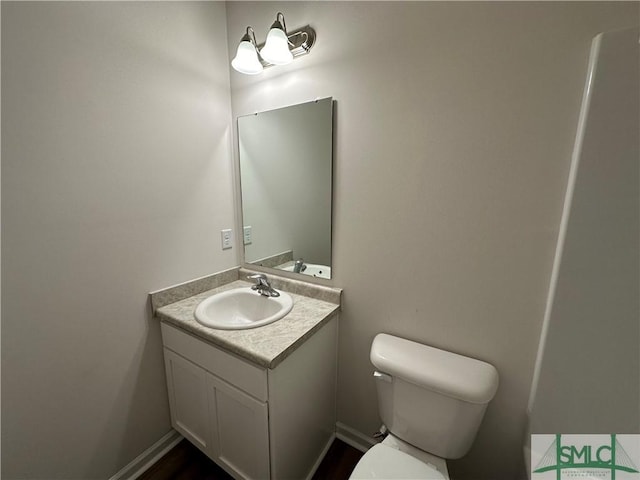 bathroom featuring vanity and toilet