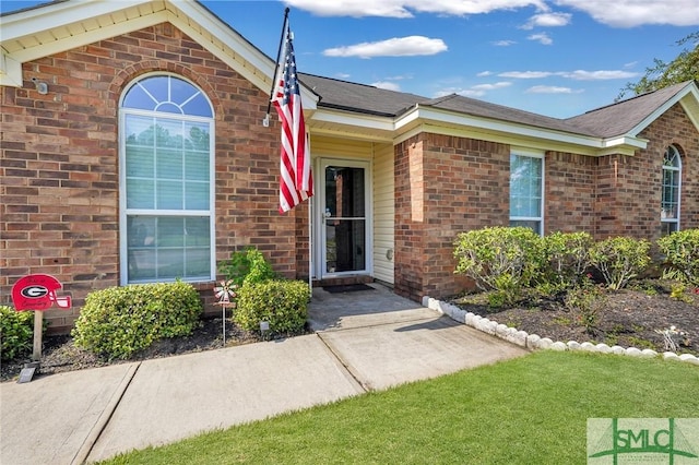 property entrance with a yard