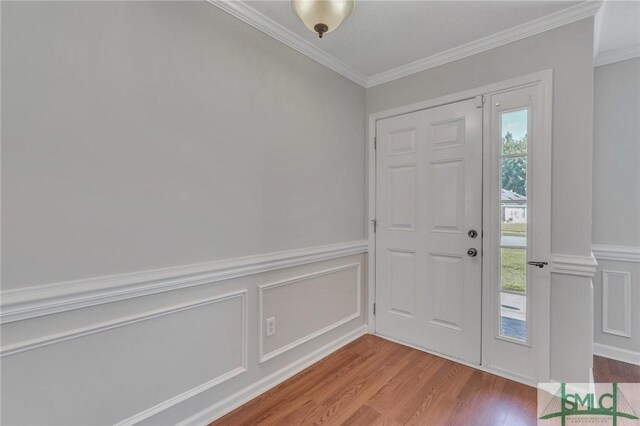 foyer entrance featuring hardwood / wood-style flooring and ornamental molding