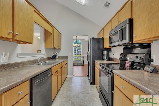 kitchen featuring lofted ceiling, sink, stainless steel appliances, and an inviting chandelier