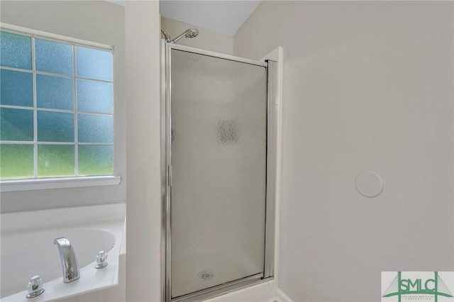 bathroom featuring shower with separate bathtub