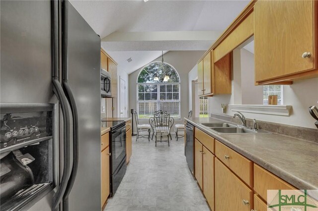 kitchen with light tile patterned floors, appliances with stainless steel finishes, vaulted ceiling, sink, and decorative light fixtures