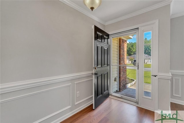 foyer featuring crown molding and hardwood / wood-style floors