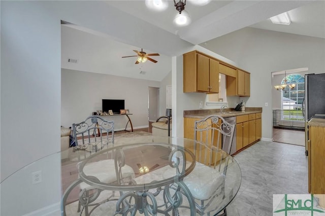 dining space with high vaulted ceiling, sink, and ceiling fan with notable chandelier