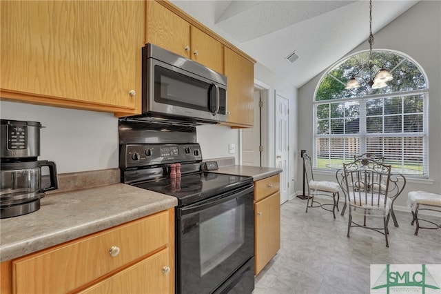 kitchen featuring light tile patterned floors, black range with electric cooktop, vaulted ceiling, and a wealth of natural light