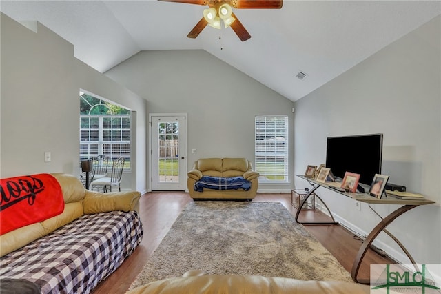 living room with ceiling fan, high vaulted ceiling, hardwood / wood-style flooring, and a healthy amount of sunlight