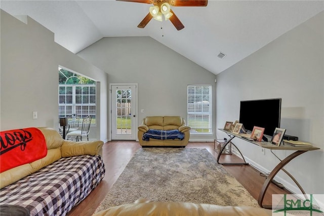 living room with wood-type flooring, high vaulted ceiling, and ceiling fan