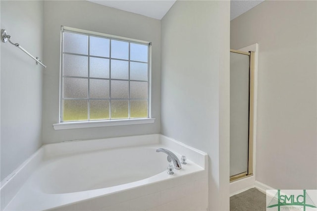 bathroom with separate shower and tub