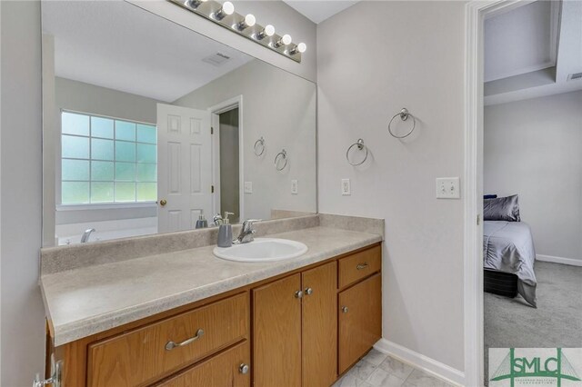 bathroom featuring vanity, a bathing tub, and tile patterned flooring