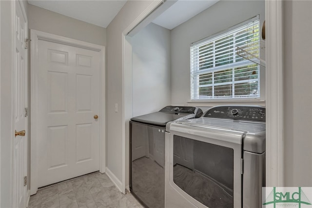 laundry room featuring light tile patterned floors and washer and clothes dryer