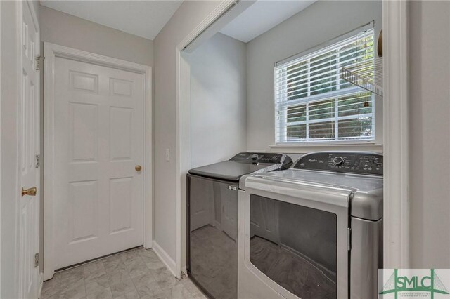 clothes washing area with washer and dryer