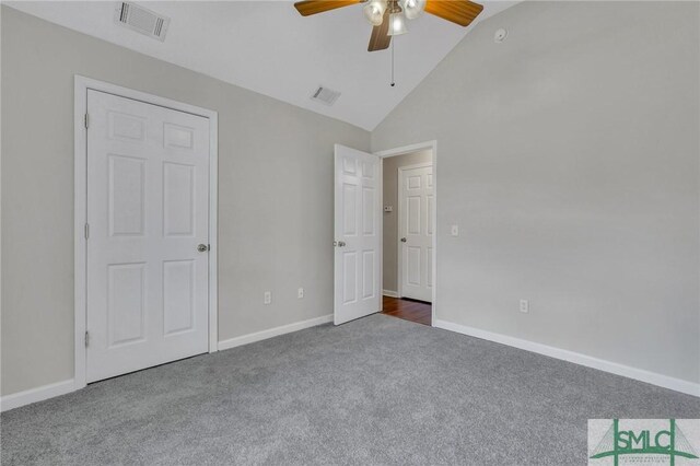 unfurnished bedroom featuring high vaulted ceiling, ceiling fan, and carpet floors