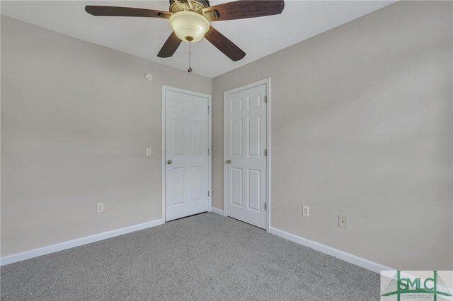 unfurnished bedroom featuring light carpet and ceiling fan