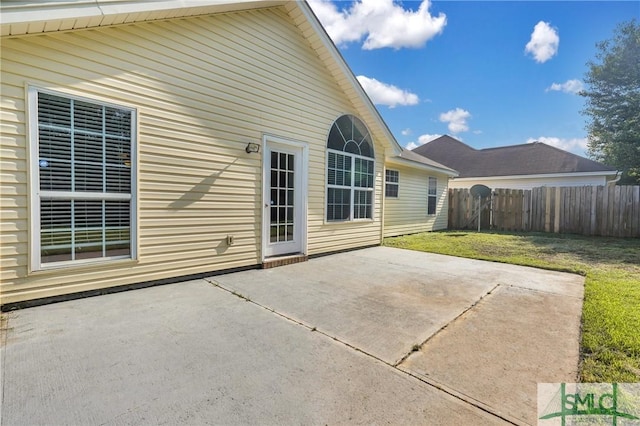 back of property featuring a patio and a lawn